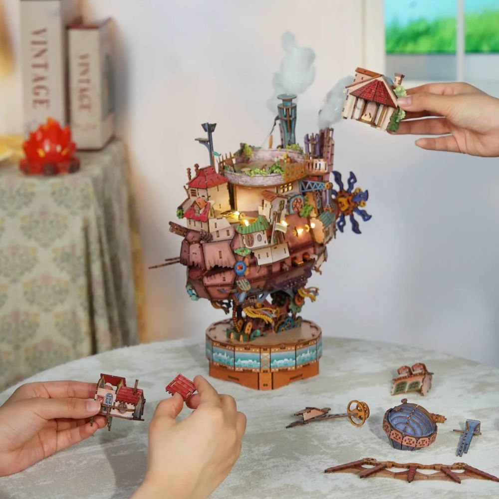 Articulated mechanical legs on Moving Castle 3D wooden puzzle : gears and pipes steampunk base detail