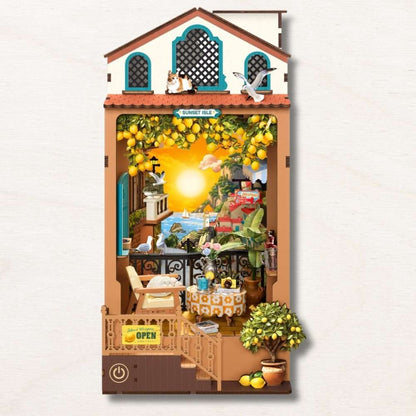 Sunset Isle book nook DIY assembled — Mediterranean coastal village with turquoise windows and warm sunset LED glow