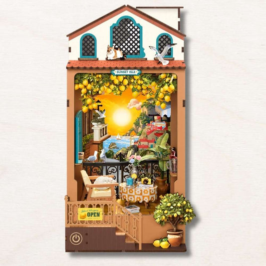 Sunset Isle book nook DIY assembled — Mediterranean coastal village with turquoise windows and warm sunset LED glow