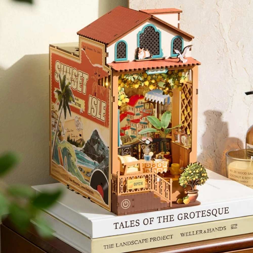Sunset Isle book nook sunset LED mode — warm amber orange glow filling Mediterranean terrace interior